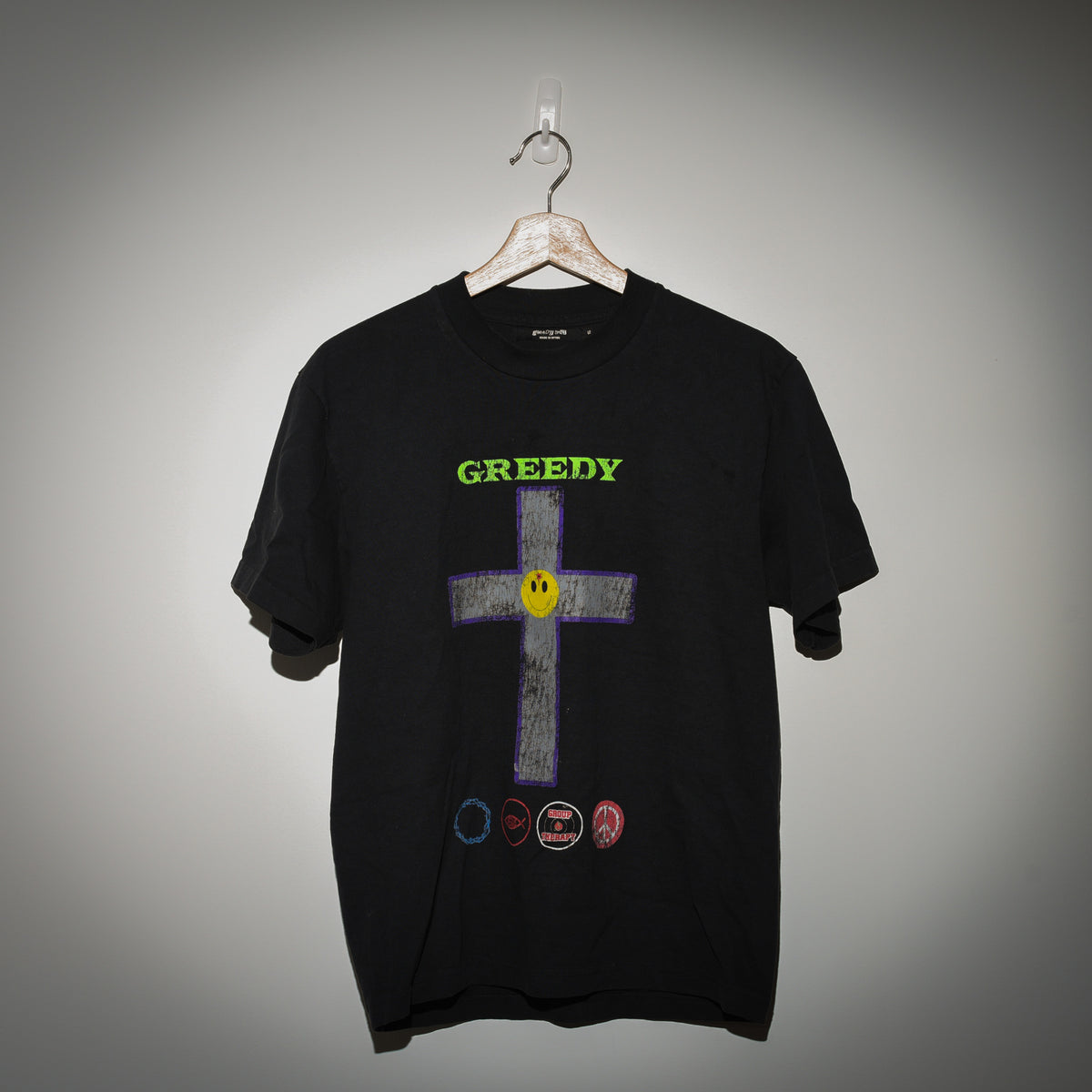 Greedy Unit Stone Believer tee front view showing GREEDY cross graphic