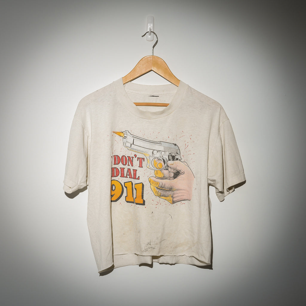Vintage I Don't Dial 911 tee full view on hanger showing cropped fit