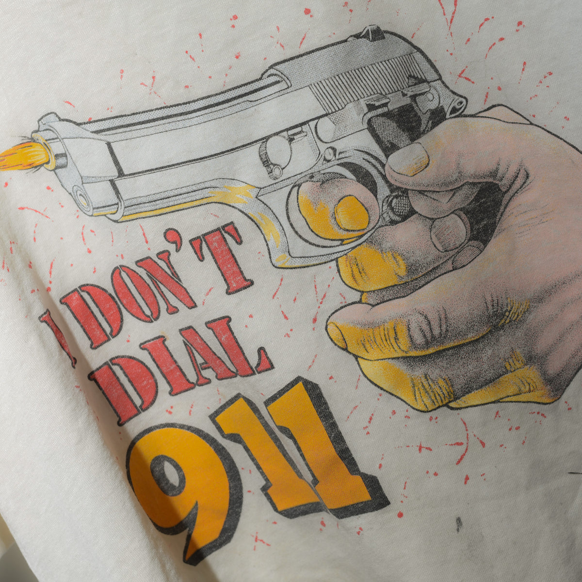 Vintage I Don't Dial 911 tee close up graphic detail with pistol and red splatter