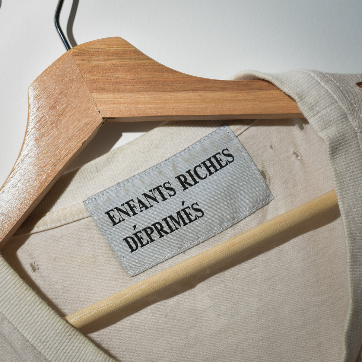 Enfants Riches Déprimés woven neck label close up