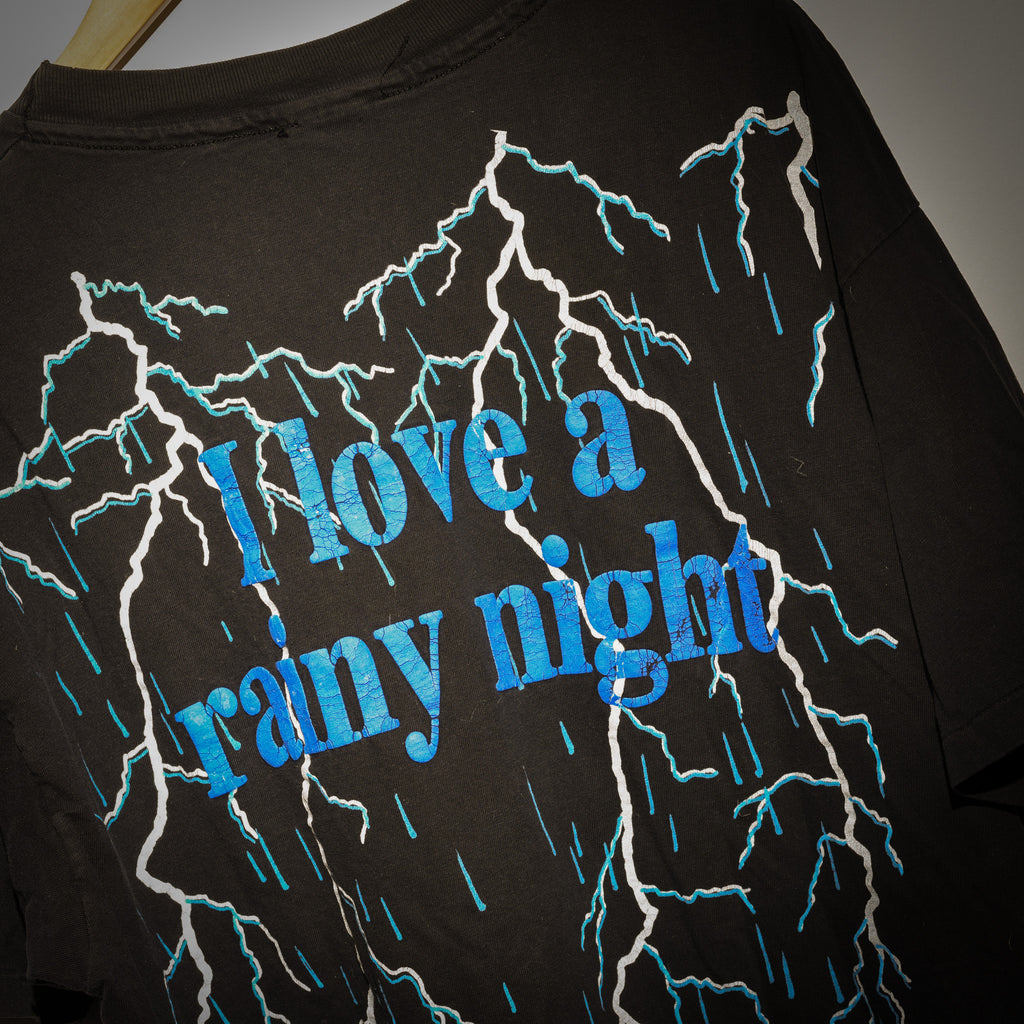 Vintage Eddie Rabbitt I Love a Rainy Night tee back graphic close up with cracked blue foil lettering