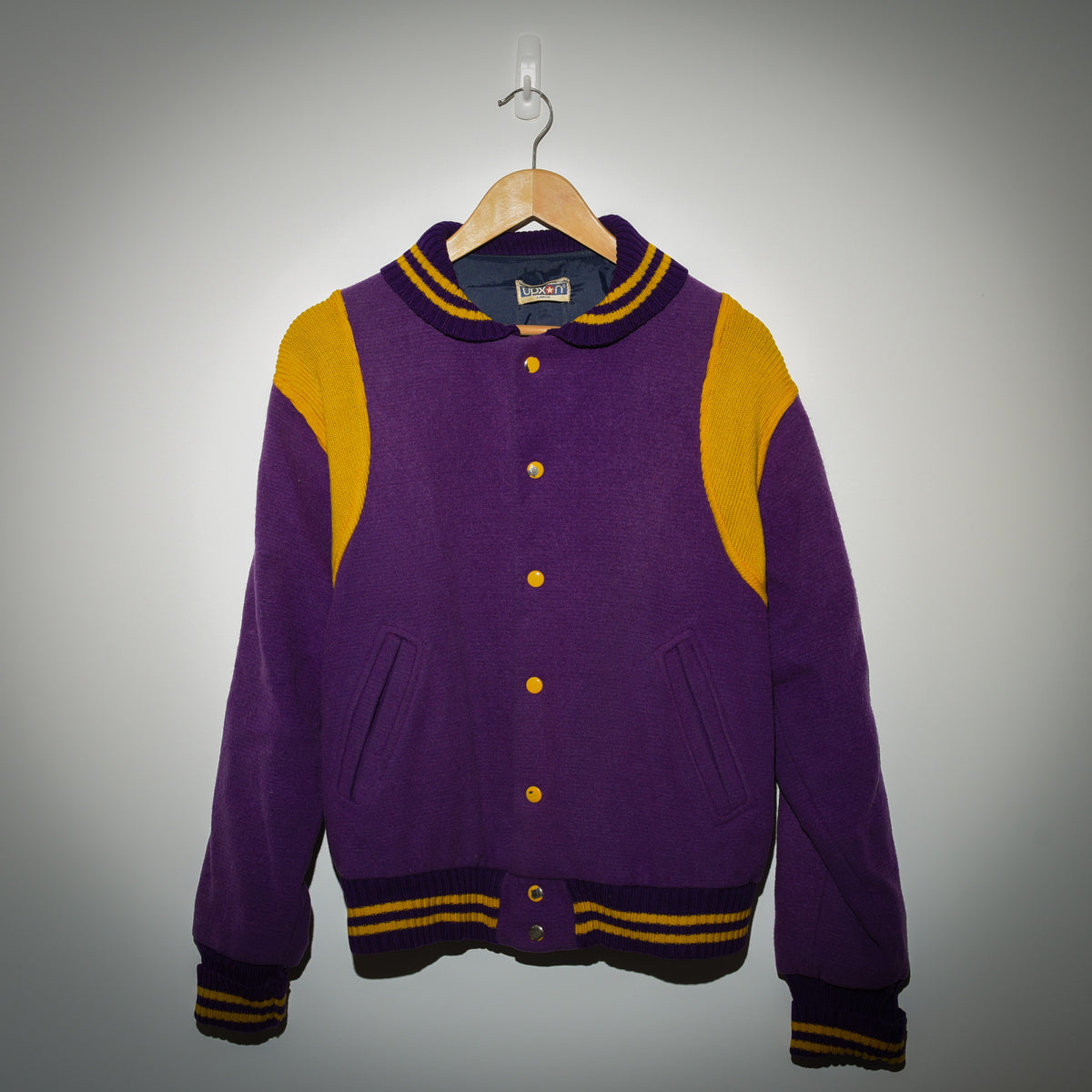 Vintage Duxon purple and gold varsity jacket full front view on hanger