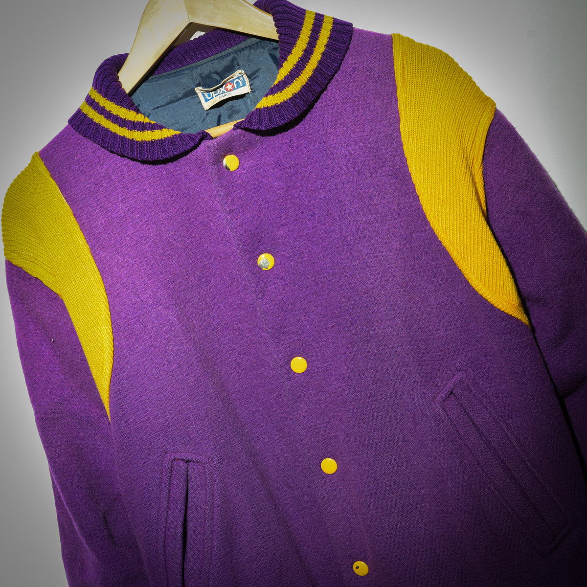 Vintage Duxon varsity jacket front close up showing gold snap buttons and knit detail