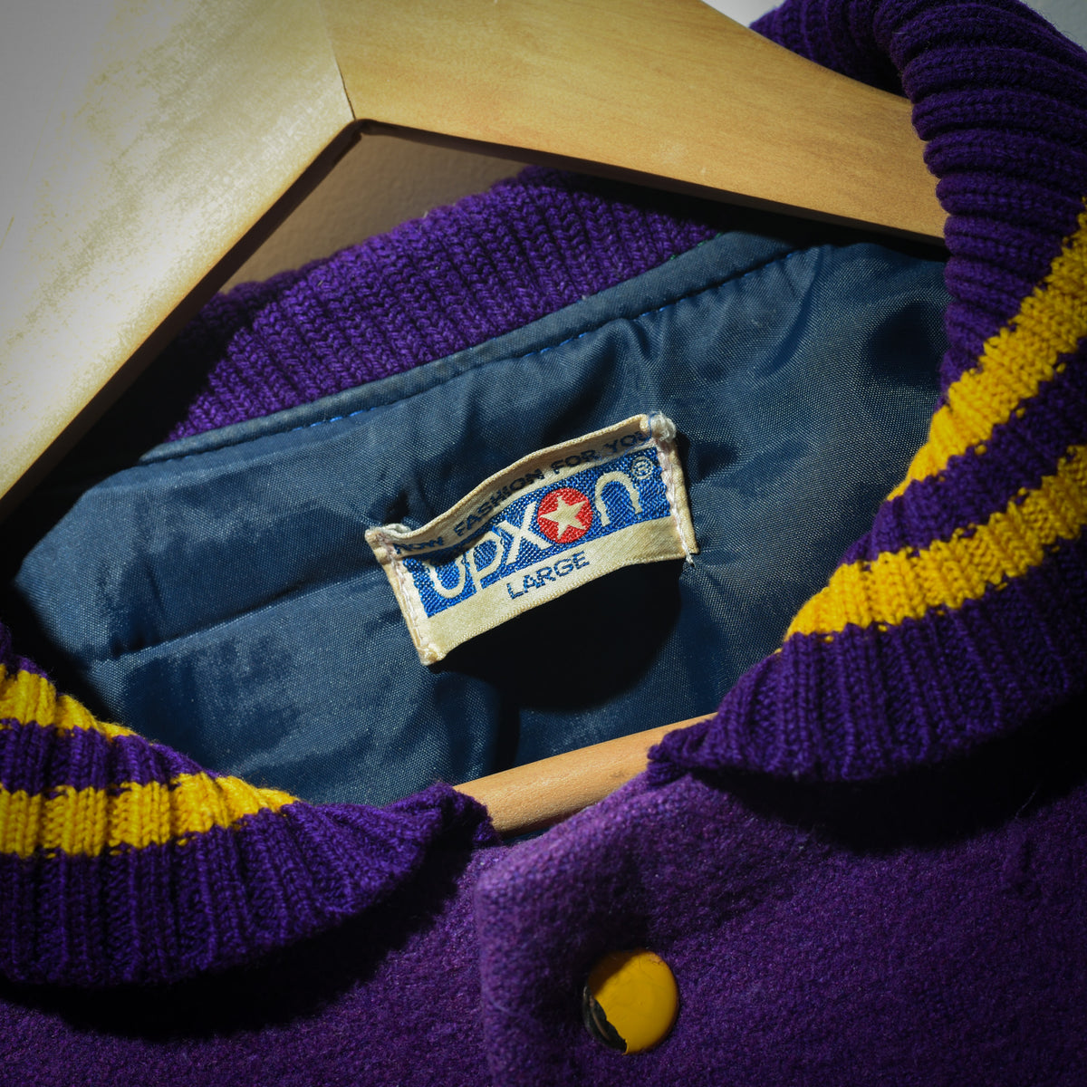 Vintage Duxon varsity jacket interior showing blue satin lining and Duxon label