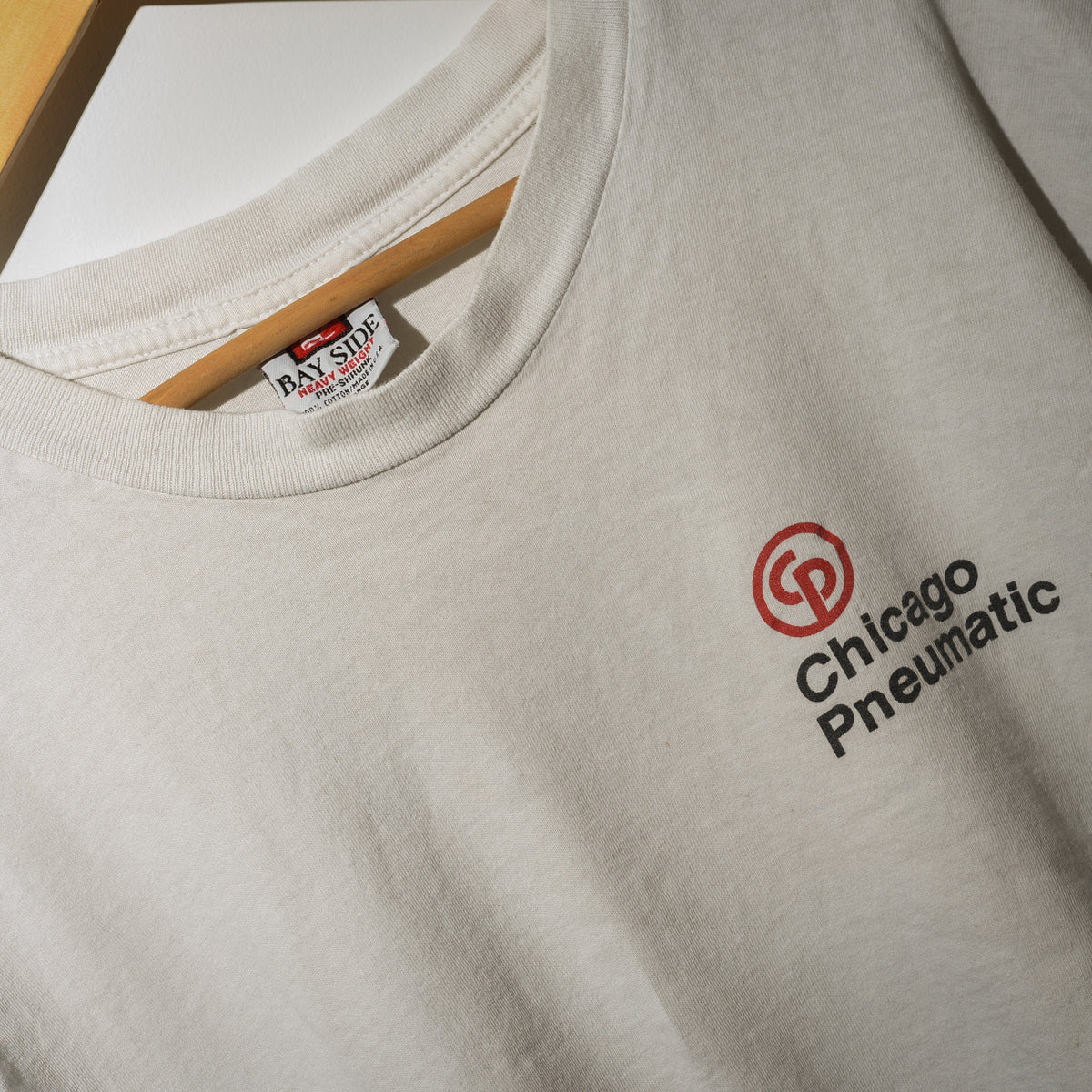 Vintage Chicago Pneumatic tee label and chest logo close up