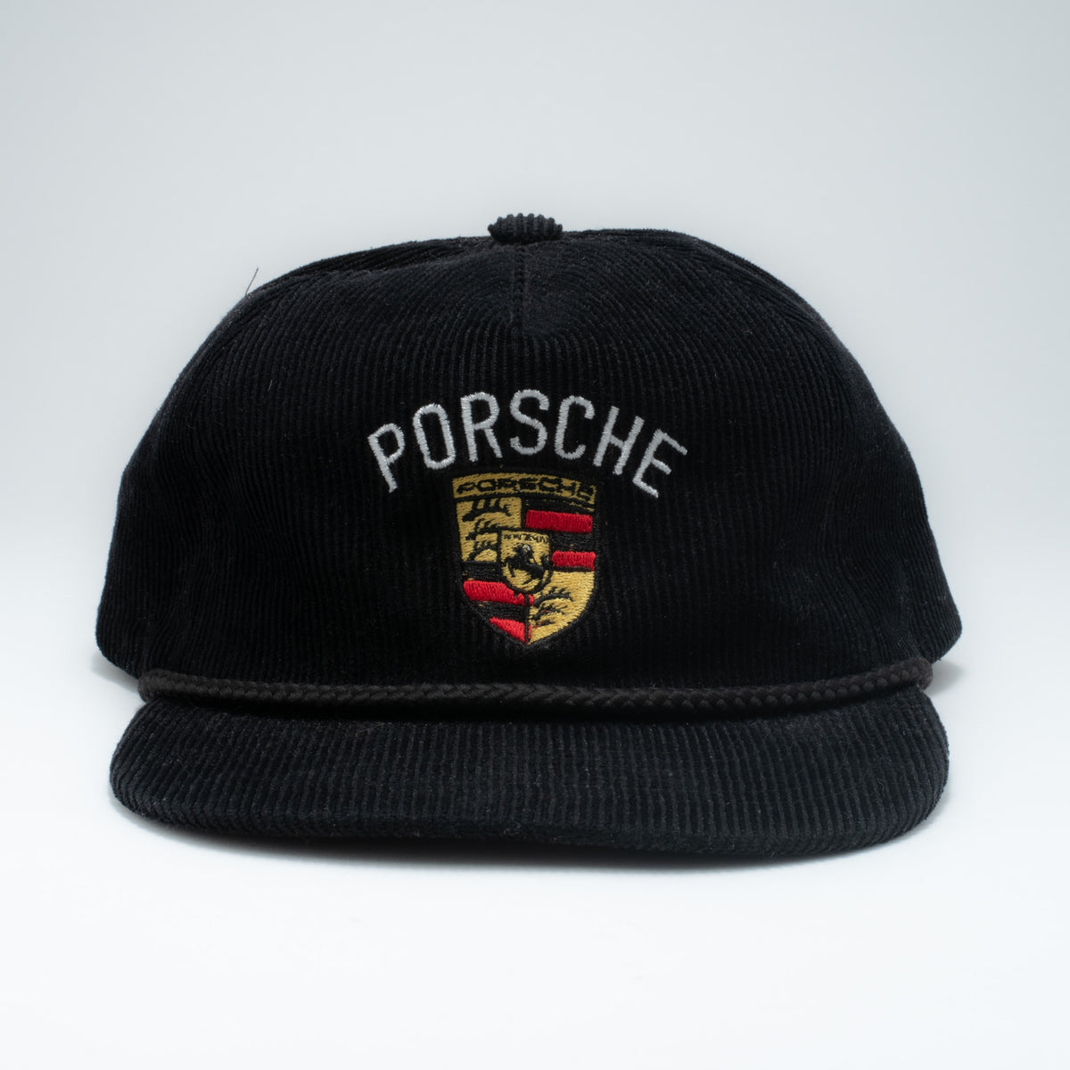 Vintage Porsche corduroy snapback hat front view showing embroidered crest and PORSCHE lettering