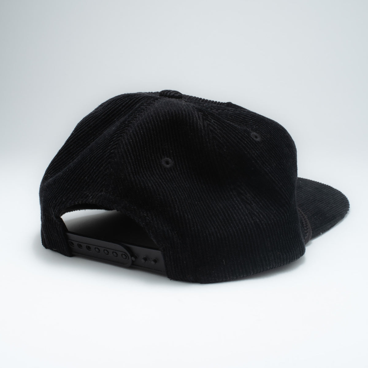 Vintage Porsche corduroy snapback hat back view showing black plastic snapback closure