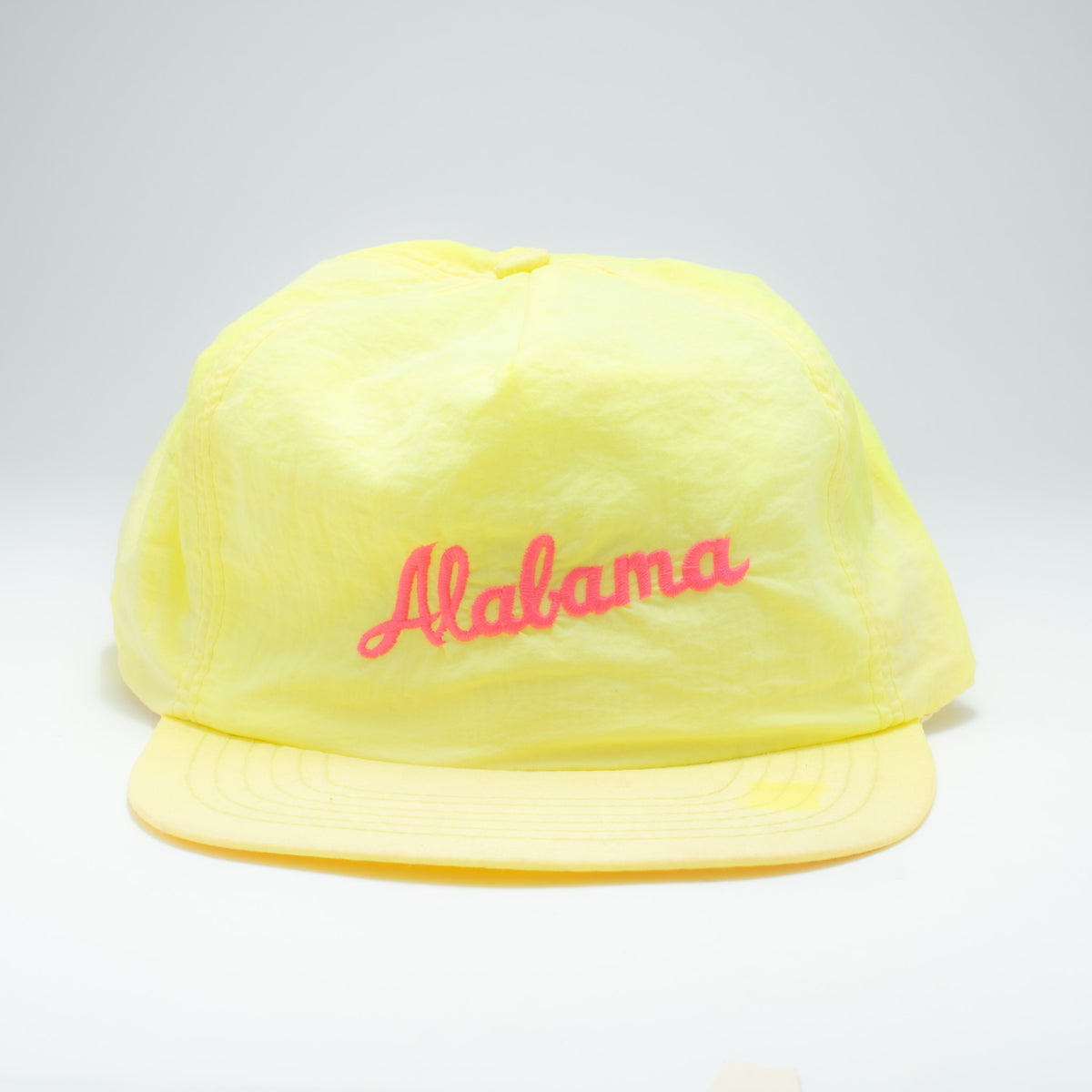 Vintage Alabama neon nylon snapback hat front view showing hot pink script lettering on acid yellow