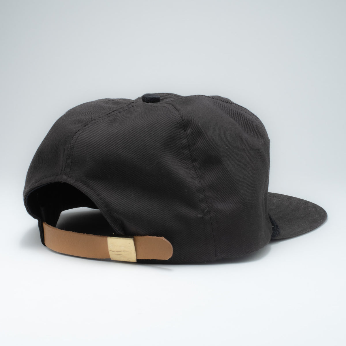 Vintage Furadan 5-panel strapback hat back view showing tan leather strap with gold hardware