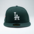 New Era LA Dodgers forest green fitted hat front view showing white LA embroidery and World Series patch