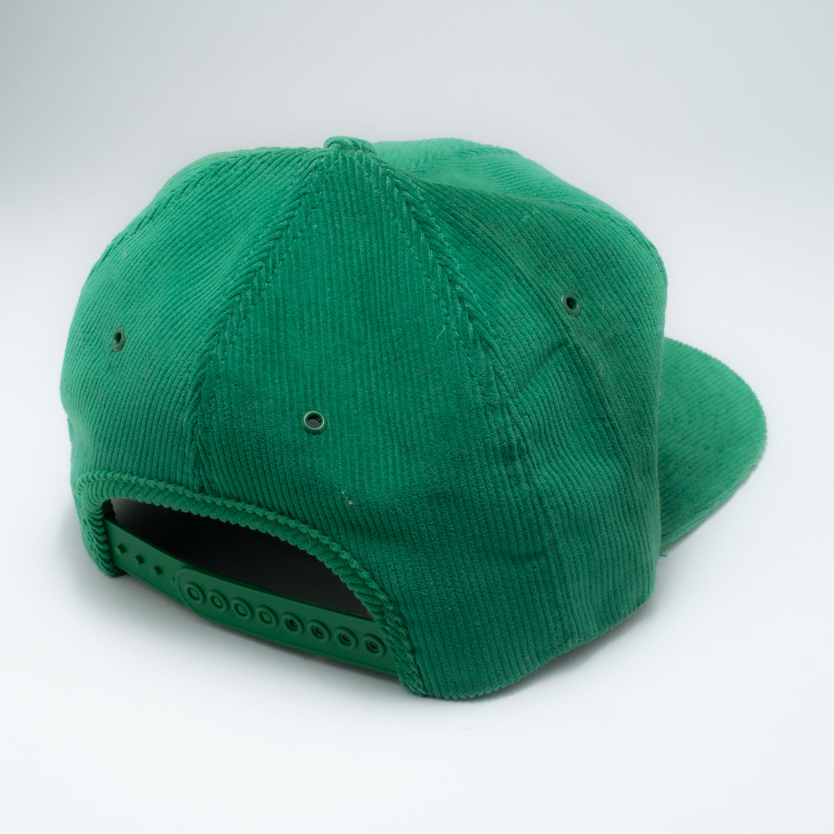 Vintage green corduroy snapback hat back view showing green plastic snapback closure