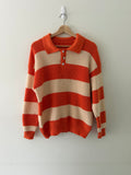 Vintage knit stripe polo sweater front view showing burnt orange and cream wide stripes and white shell buttons