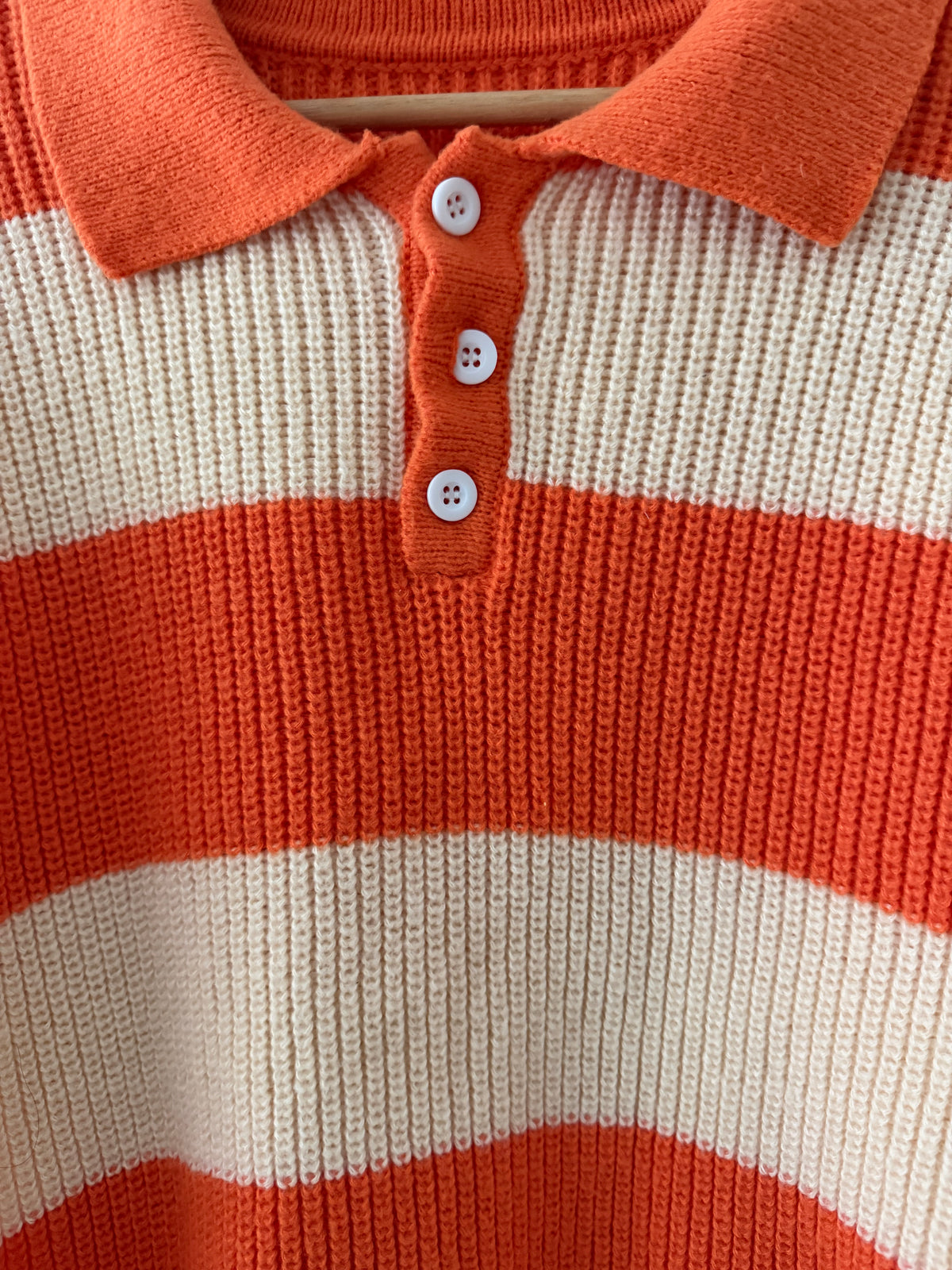 Vintage knit stripe polo sweater close up of collar and three white shell buttons on burnt orange placket