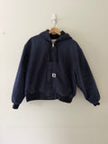 Vintage Carhartt WIP active hooded jacket front view in faded navy showing woven C patch and full zip
