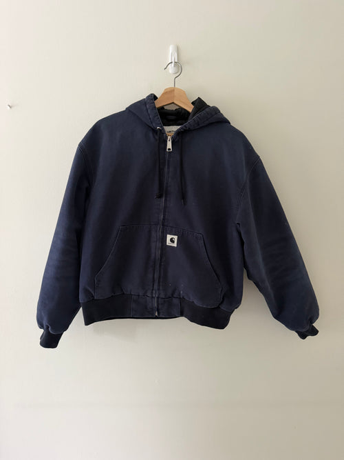 Vintage Carhartt WIP active hooded jacket front view in faded navy showing woven C patch and full zip