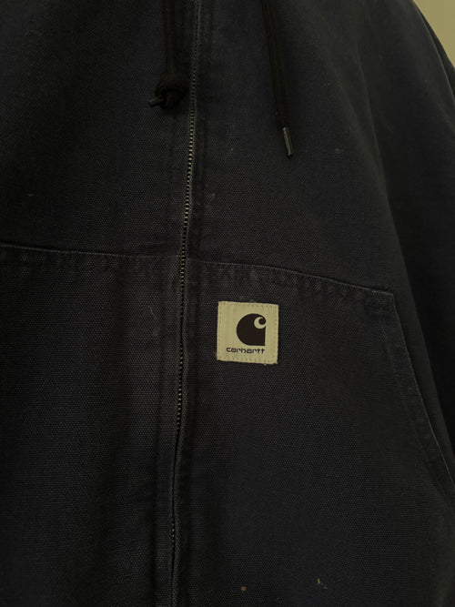Carhartt WIP jacket close up of woven C patch on kangaroo pocket and canvas texture