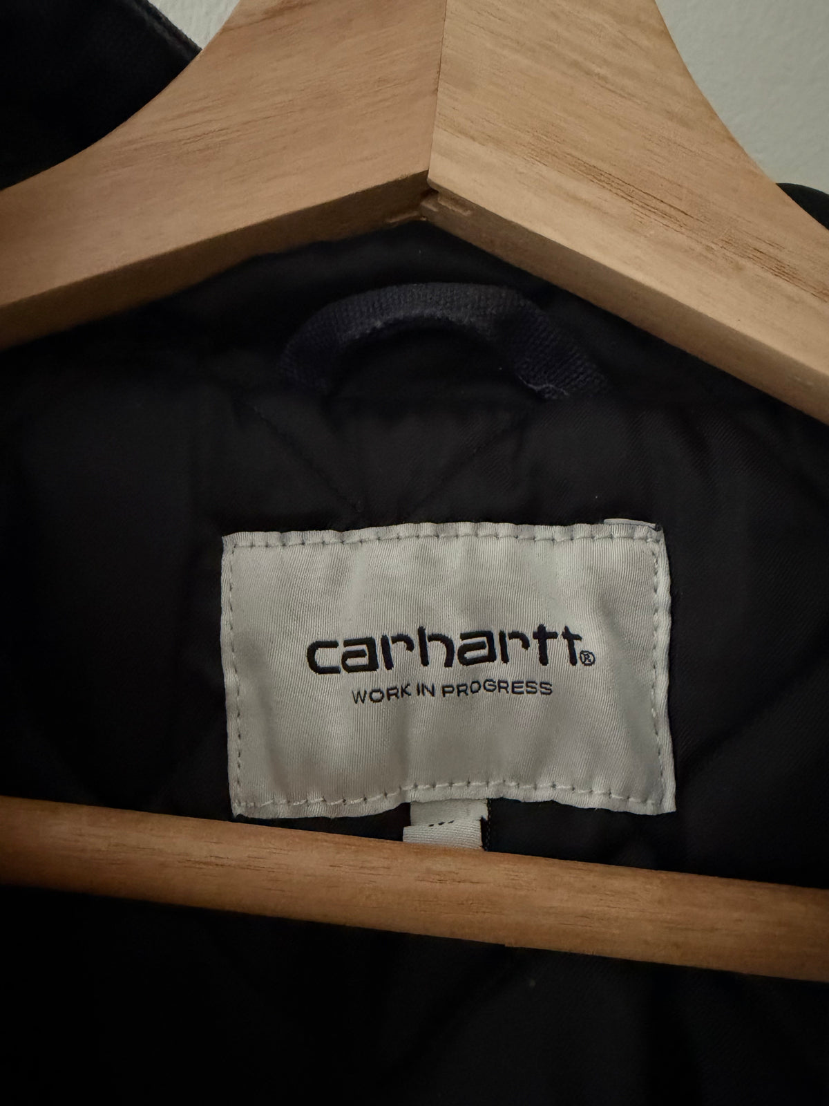 Carhartt WIP jacket interior label close up showing carhartt WORK IN PROGRESS woven label