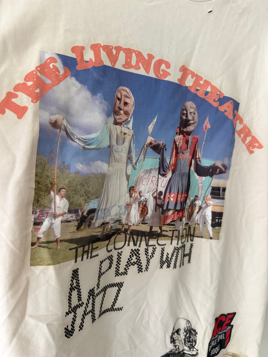 Paly Hollywood The Living Theatre tee graphic close up showing puppet performers red arch lettering and stencil text