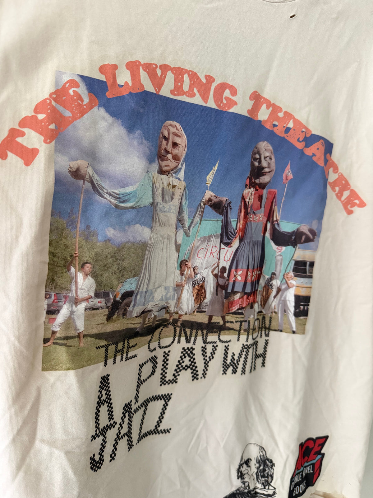 Paly Hollywood The Living Theatre tee graphic close up showing puppet performers red arch lettering and stencil text
