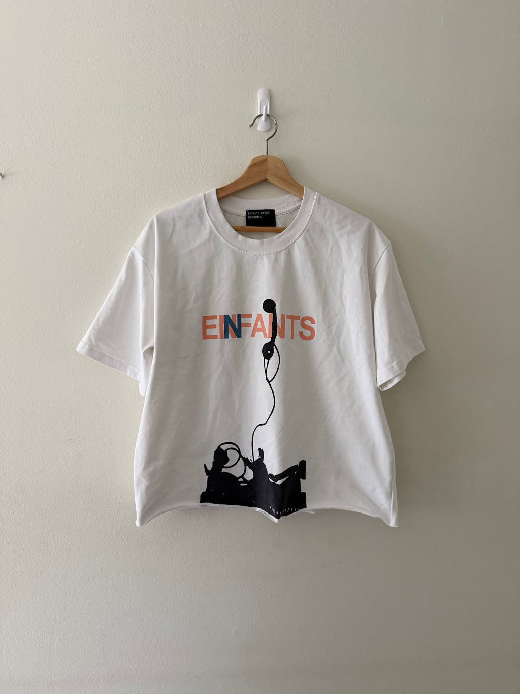 Enfants Riches Déprimés Phone tee full view showing EINFANTS lettering and telephone figure graphic on white