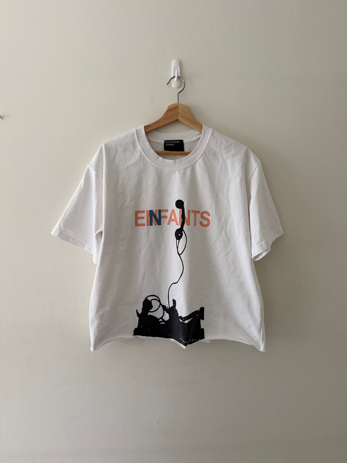 Enfants Riches Déprimés Phone tee full view showing EINFANTS lettering and telephone figure graphic on white