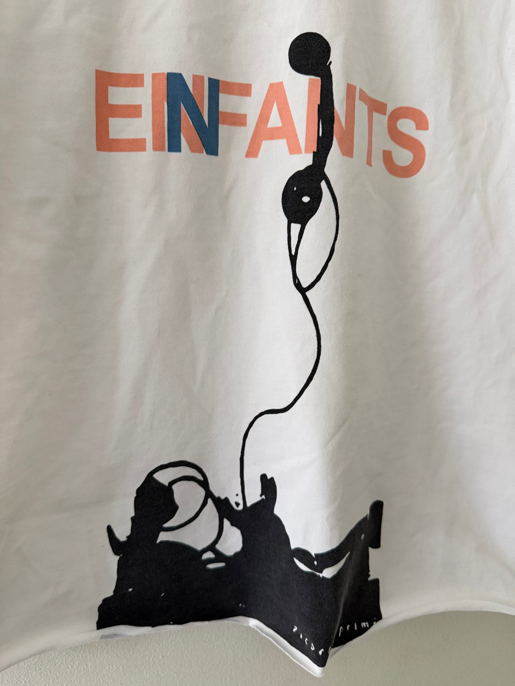 Enfants Riches Déprimés Phone tee graphic close up showing salmon navy EINFANTS lettering and bold black telephone screen print