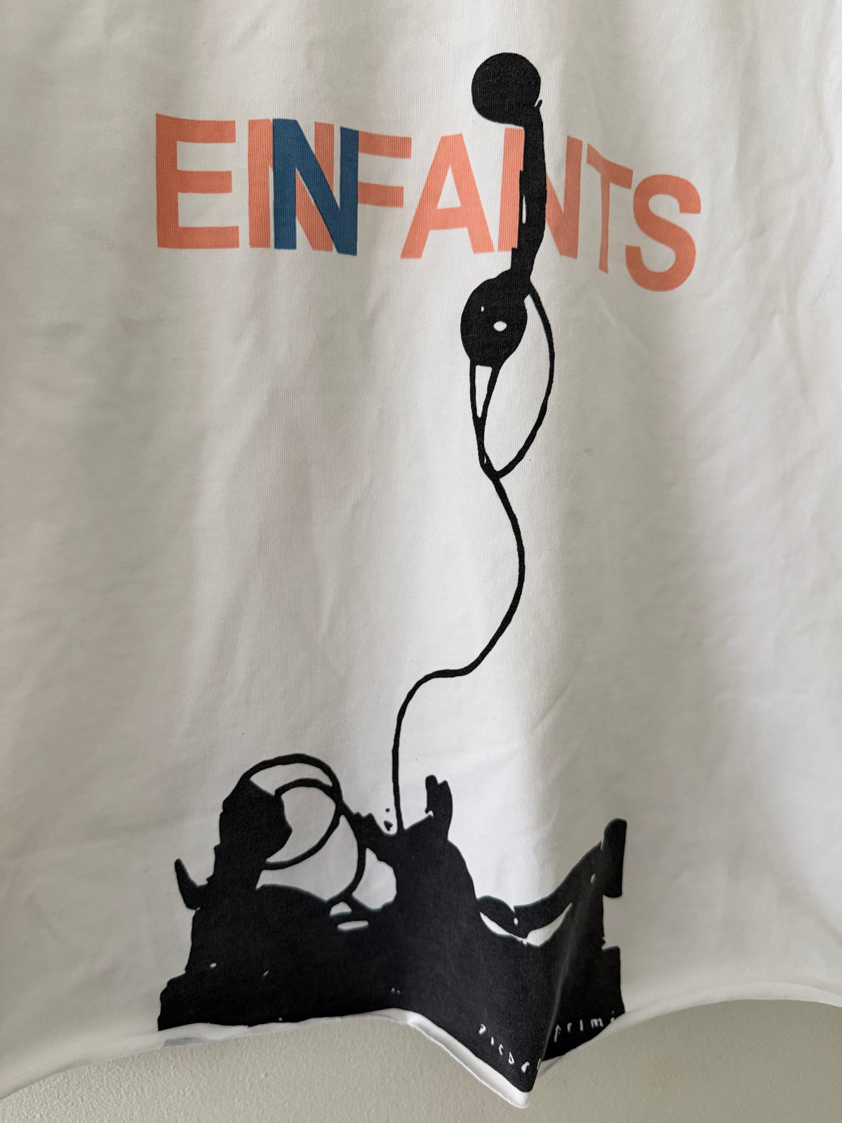 Enfants Riches Déprimés Phone tee graphic close up showing salmon navy EINFANTS lettering and bold black telephone screen print