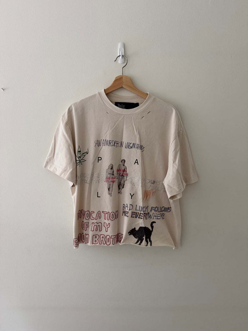 Paly Hollywood bedazzled tee front full view showing collage graphic with rhinestones cannabis leaf and black cat