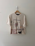 Paly Hollywood bedazzled tee front full view showing collage graphic with rhinestones cannabis leaf and black cat