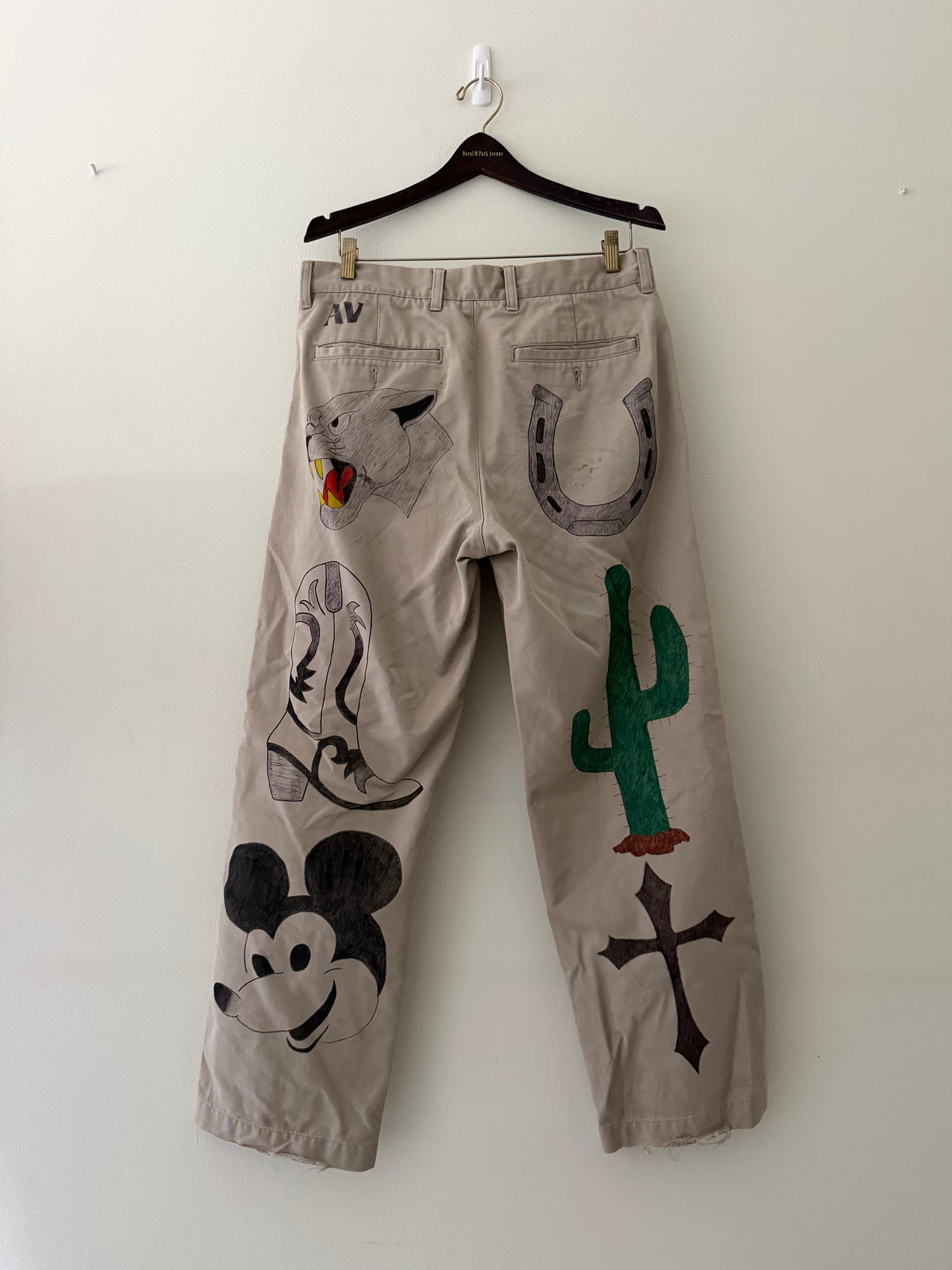 Elephant Man Original hand-drawn khaki trousers back view showing panther horseshoe cowboy boot cactus cross and Mickey Mouse