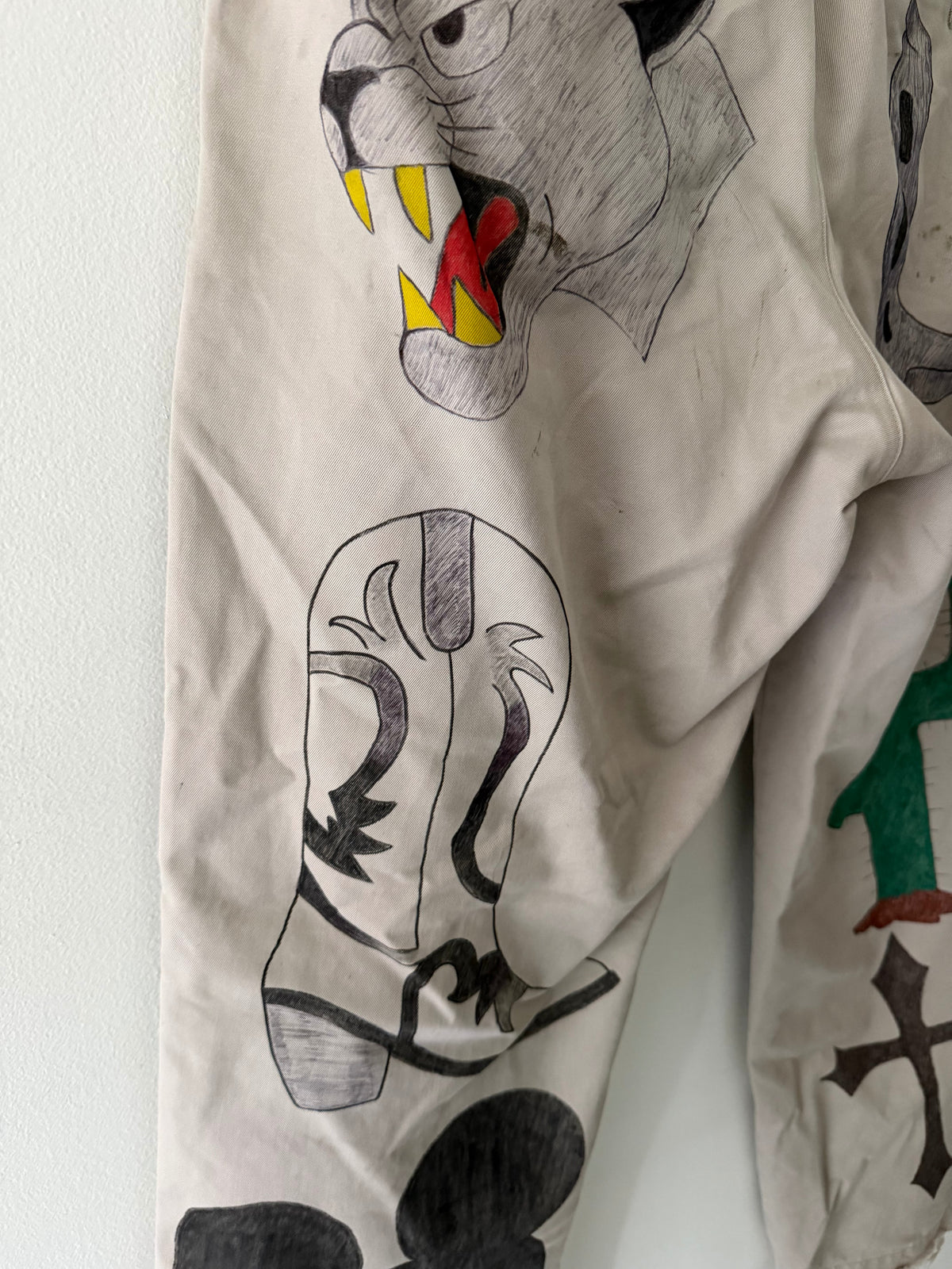 Elephant Man Original khaki trousers back graphic close up showing snarling panther with yellow fangs cowboy boot and cactus