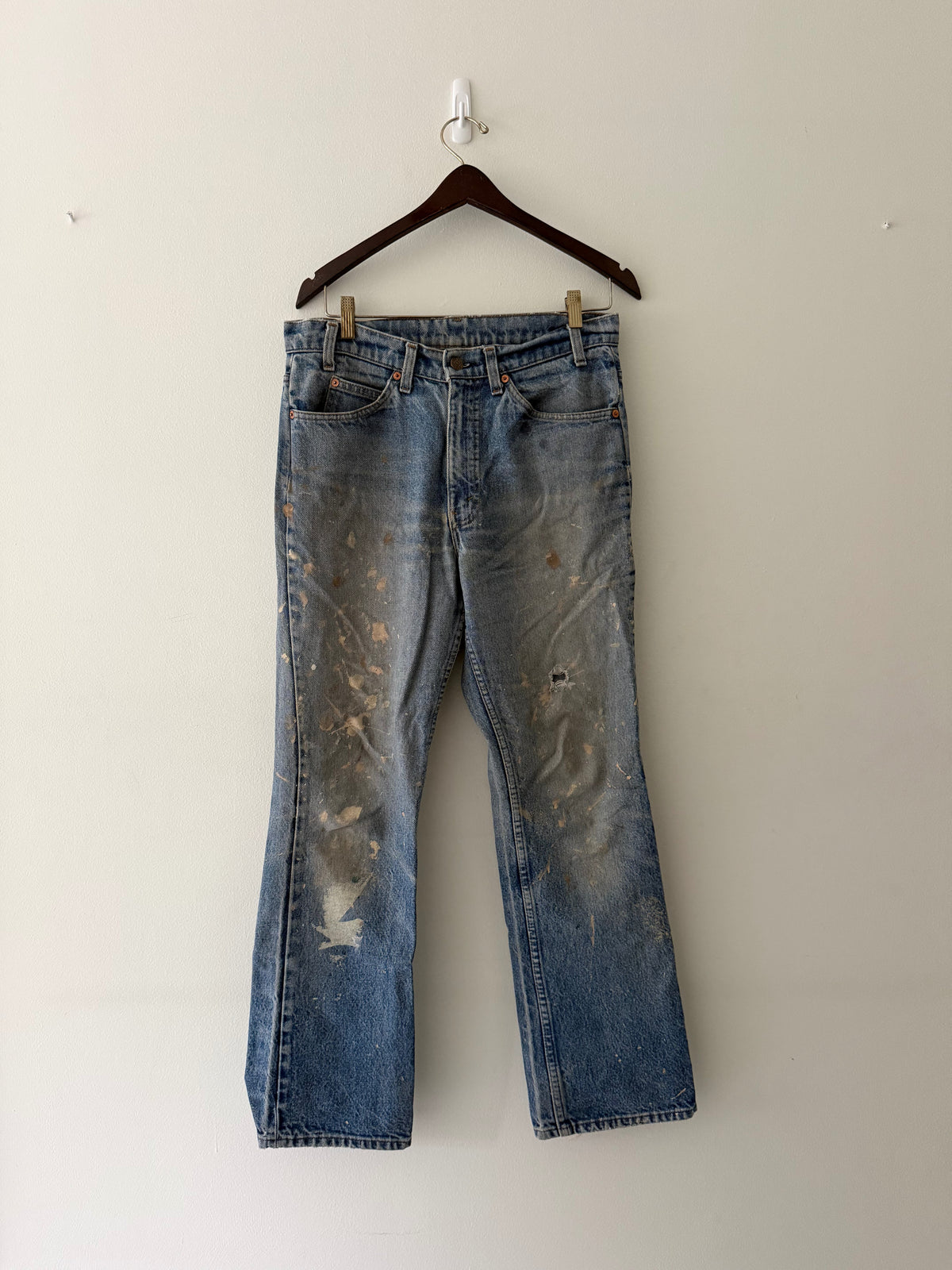 Vintage Levi's Orange Tab paint splattered denim jeans full view showing heavy paint splatter and fading