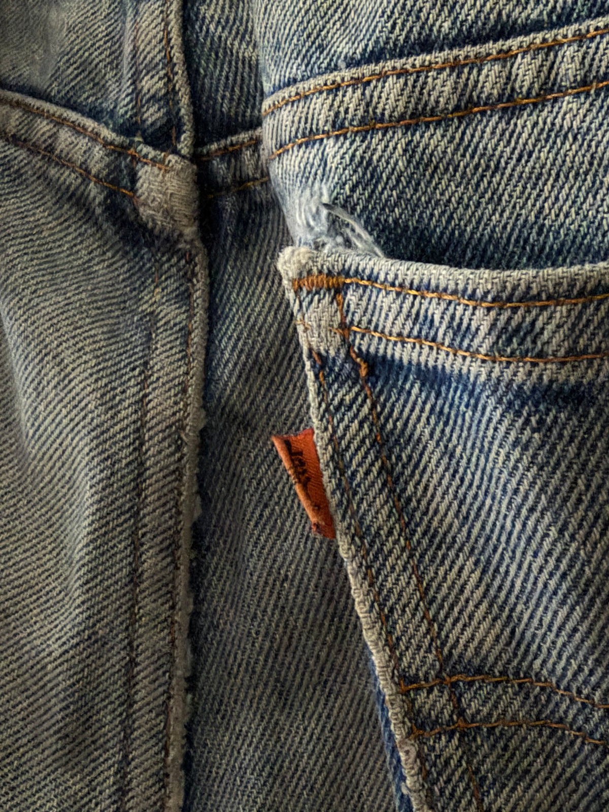 Vintage Levi's Orange Tab denim close up of orange tab on coin pocket with fraying detail