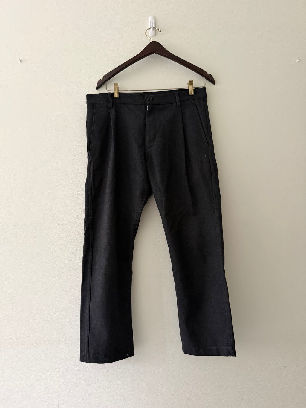 Comme des Garçons SHIRT Boys black wool trousers full view showing wide leg silhouette and double front pleats