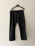 Comme des Garçons SHIRT Boys black wool trousers full view showing wide leg silhouette and double front pleats