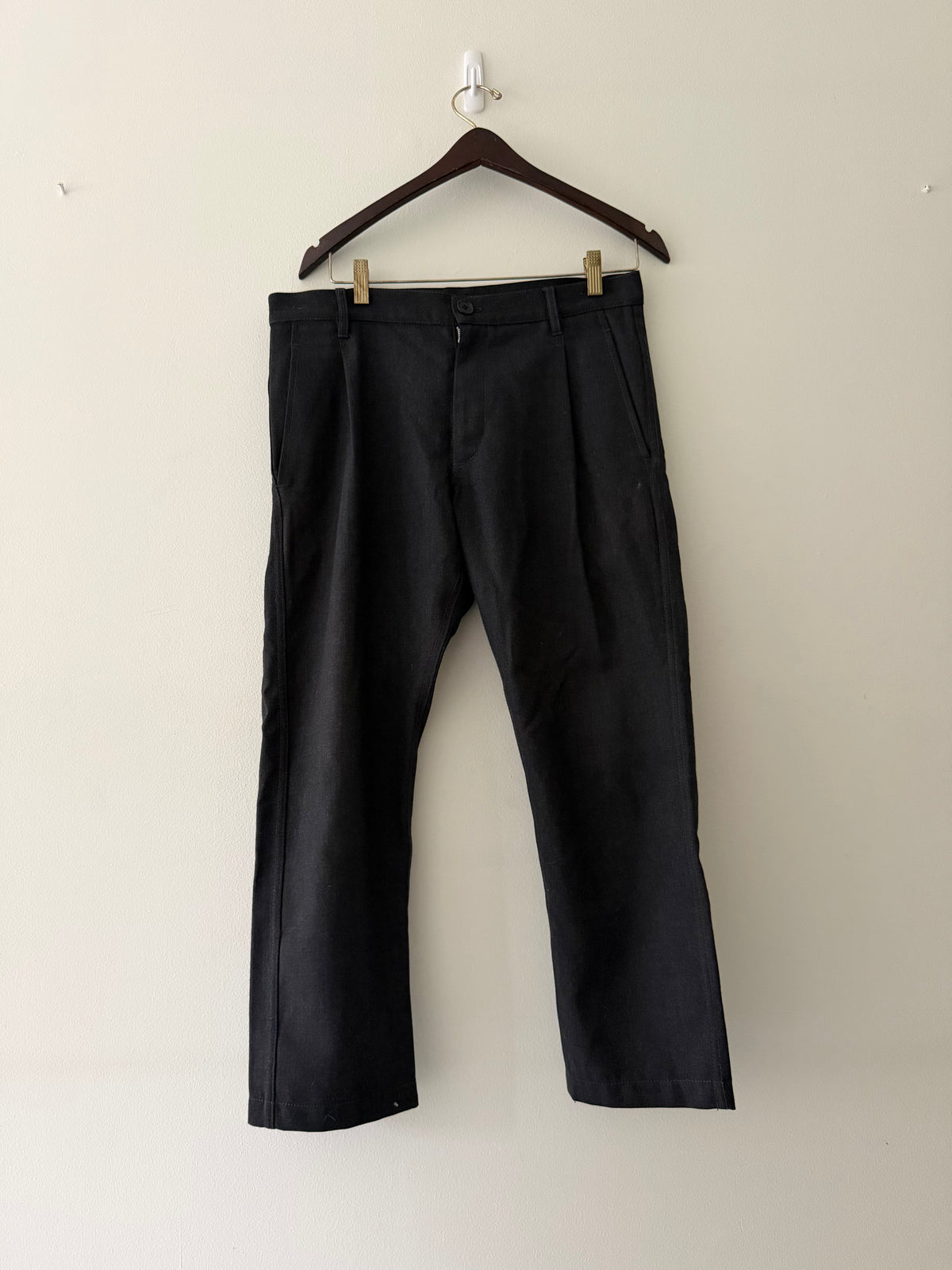 Comme des Garçons SHIRT Boys black wool trousers full view showing wide leg silhouette and double front pleats