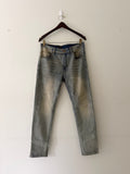 Dior mud-washed slim fit denim front view showing light blue wash with warm ochre tonal fading