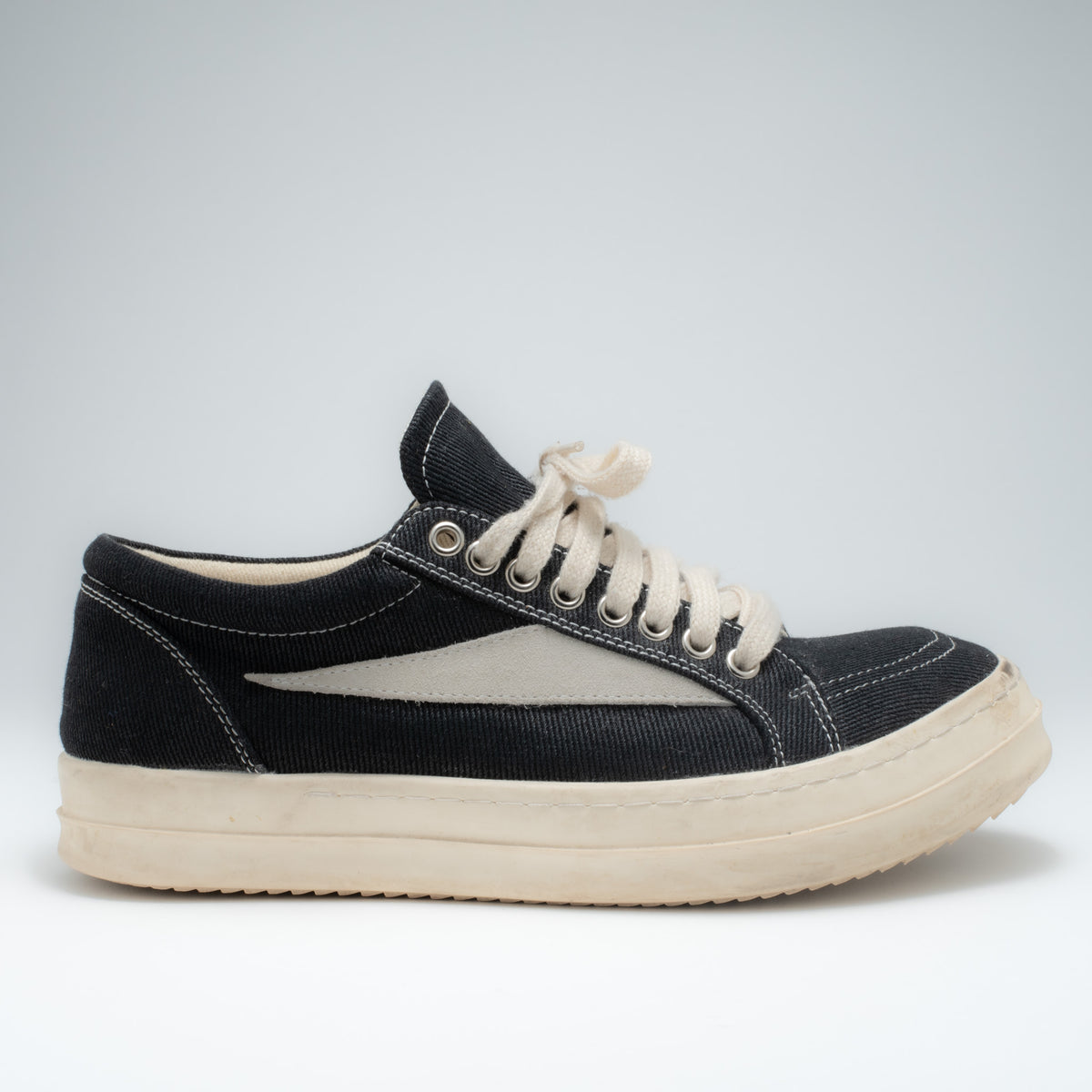 Rick Owens DRKSHDW canvas sneaker side profile view showing cream panel flash and contrast stitching